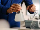 Service man testing water at kitchen sink.